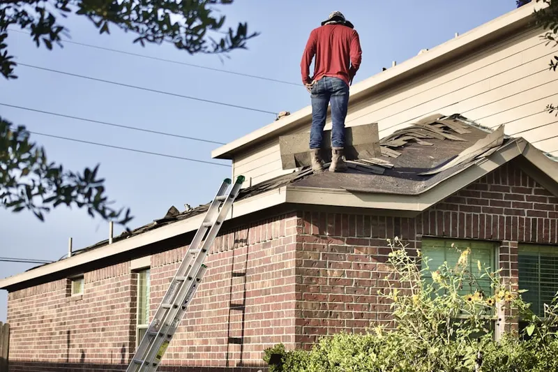 Professional roofer working on a residential roof in East Front